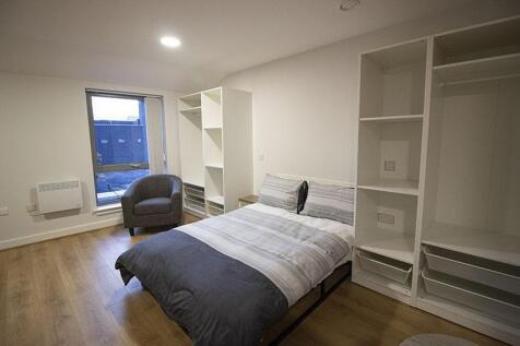 Bright and cozy master bedroom featuring a comf...