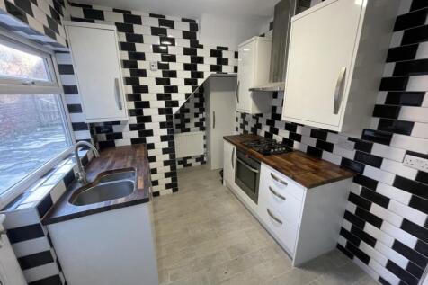 A modern and stylish kitchen with a unique blac...
