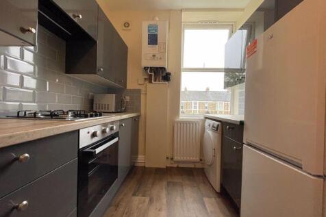 A modern, well-maintained kitchen featuring sle...