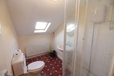 Bright bathroom featuring a skylight that fills...