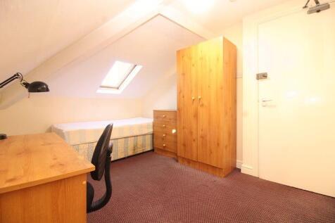 Bright and cozy single bedroom featuring a comf...