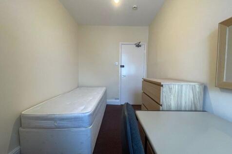 A simple, tidy single bed accommodation room fe...
