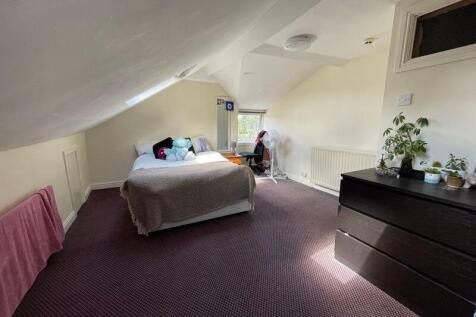 Bright and spacious attic bedroom featuring a c...