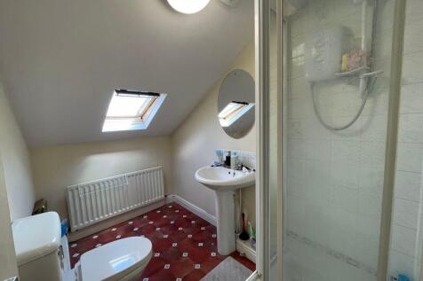 Bright and tidy bathroom featuring a skylight t...