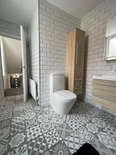 A stylish bathroom suite featuring decorative p...