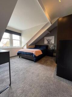 A cozy double bedroom featuring a comfortable b...