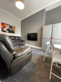 A modern living room featuring comfortable leat...