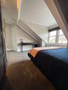 A cozy double bedroom featuring a comfortable b...