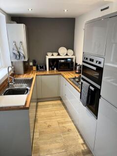 A modern, well-maintained kitchen featuring sle...