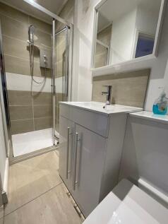 Modern bathroom featuring a sleek walk-in showe...