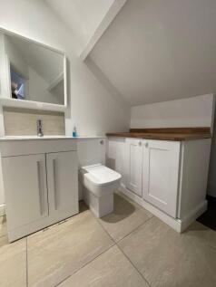 Modern bathroom featuring a sleek white vanity ...