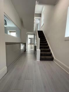 Bright and clean hallway with modern light grey...