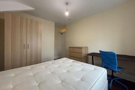 Bright and spacious master bedroom featuring a ...
