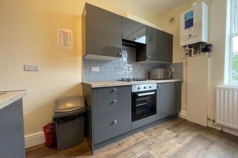 Bright and modern kitchen featuring sleek grey ...