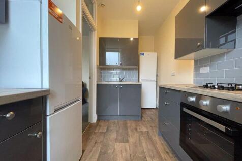Modern kitchen featuring ample storage with sle...