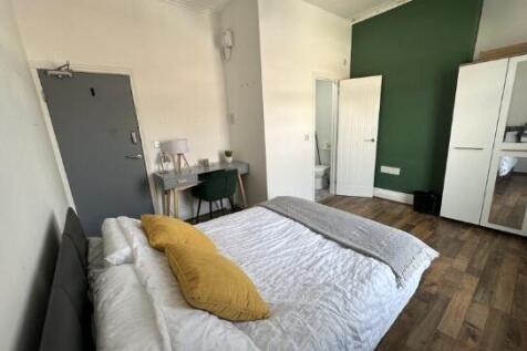 Bright and stylish master bedroom featuring a c...