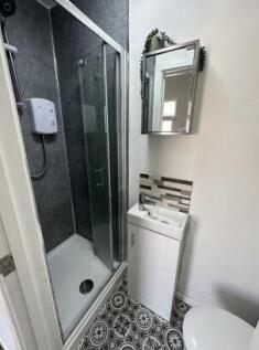 Bright and modern bathroom featuring a sleek gl...