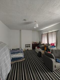 A spacious living room featuring a bold black a...