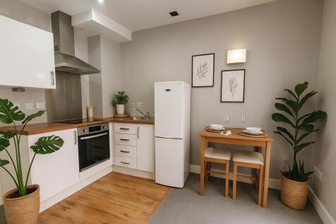 Bright and modern kitchen featuring stylish whi...