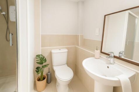 Bright and modern bathroom featuring a clean wh...
