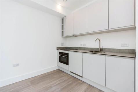 Modern and clean kitchen with sleek white cabin...