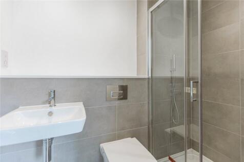 Bright and modern bathroom featuring a sleek si...