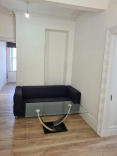 A cozy living room featuring a modern glass cof...