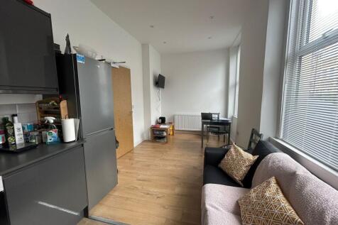 Bright and contemporary living room featuring a...
