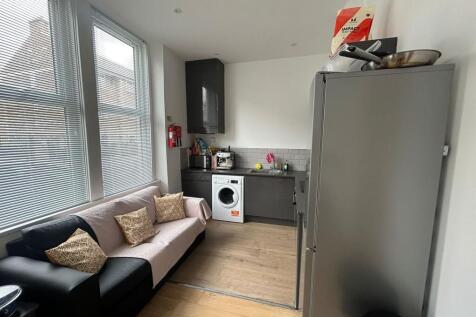 Bright and modern kitchen featuring ample natur...