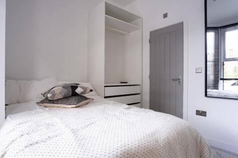Cozy double bedroom featuring a comfortable bed...