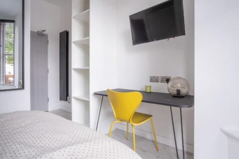 This stylish double bedroom features a cozy lay...