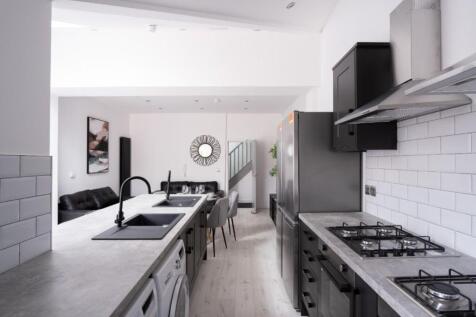 This stylish kitchen features sleek countertops...