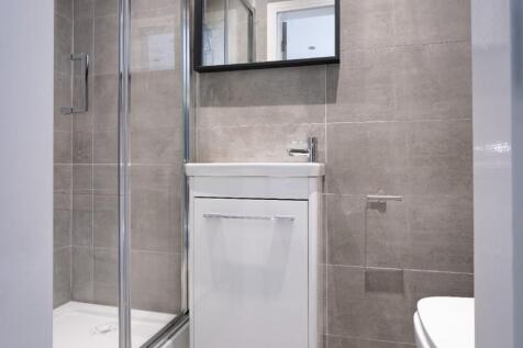 Modern bathroom suite featuring a sleek shower ...