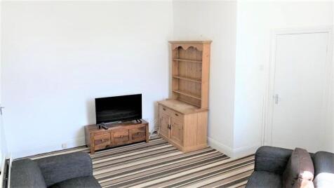 A bright and welcoming living room featuring ne...