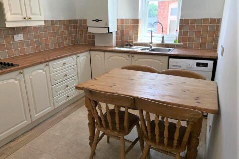 A bright kitchen with natural light from a wind...
