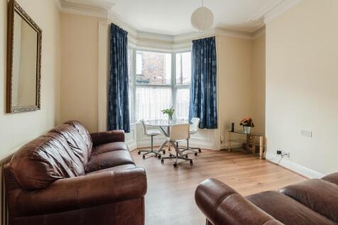 A bright and inviting living room featuring com...