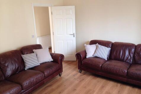 A cozy living room featuring two comfortable br...