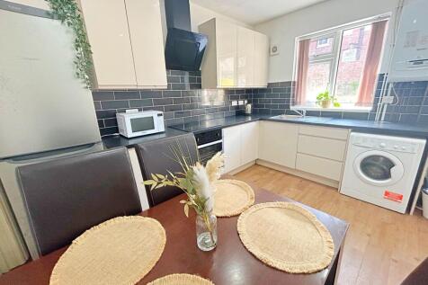 Bright and modern kitchen featuring cream cabin...