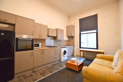 A modern kitchen area featuring ample cabinetry...