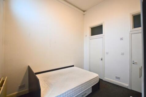 A modest double bedroom featuring a comfortable...