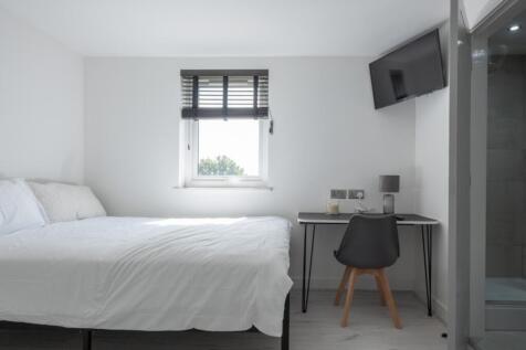 This inviting double bedroom features a comfort...
