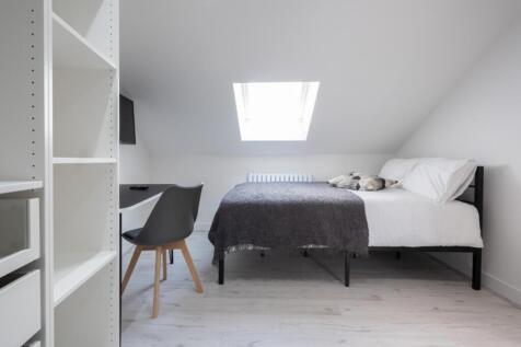This inviting double bedroom features a comfort...