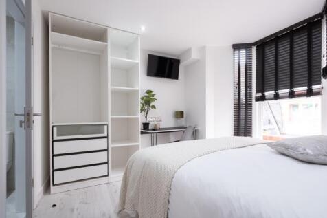 A stylish double bedroom featuring a spacious l...