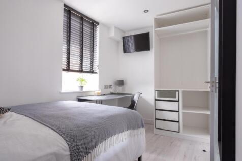 A cozy double bedroom featuring modern furnishi...