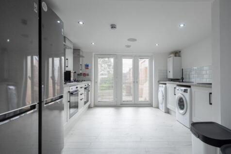 Bright and modern kitchen featuring sleek appli...