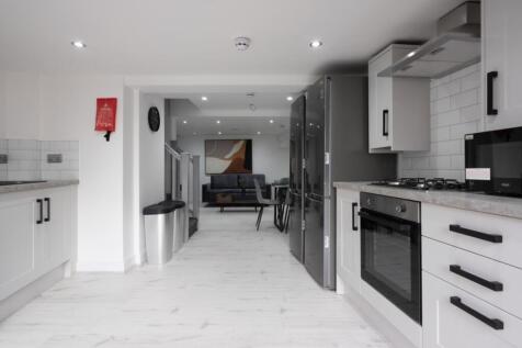 A modern kitchen featuring sleek cabinetry, amp...