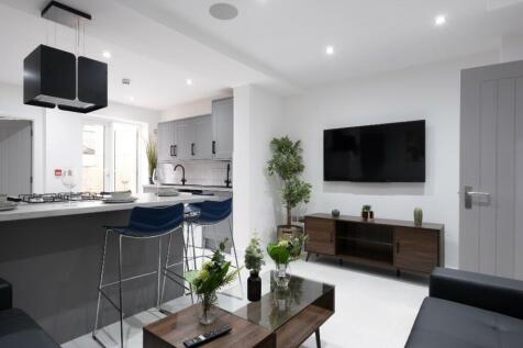 This stylish living room features a modern desi...