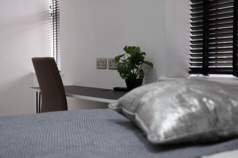 This inviting double bedroom features a comfort...