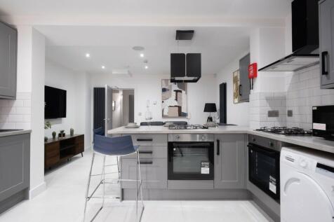 A modern kitchen featuring sleek cabinetry and ...