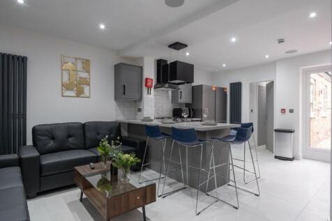 Modern kitchen featuring sleek cabinetry, ample...